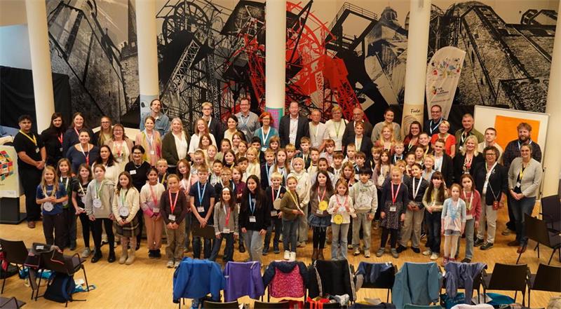 Gruppenfoto mit zahlreichen Kindern und Erwachsenen bei einer gemeinsamen Veranstaltung.