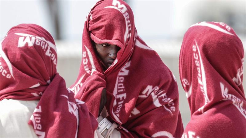 Auf See gerettete Migranten warten im Port de Commerce in Nordfrankreich.