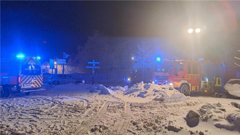 Einsatzfahrzeuge der Feuerwehr stehen im Schnee.