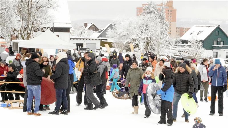 Etliche Menschen versammeln sich auf der verschneiten Skiwiese Rose.