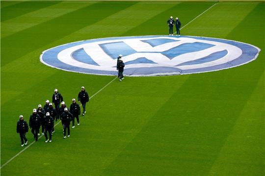 Balljungen verlassen nach dem Ausbreiten des Volkswagen-Logos vor dem Spiel den Platz.