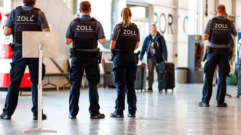 Beamten kontrollieren einzelne Passagiere.