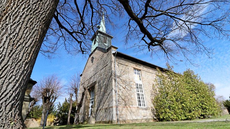Eine Kirche bei Sonnenschein und blauem Himmel. 