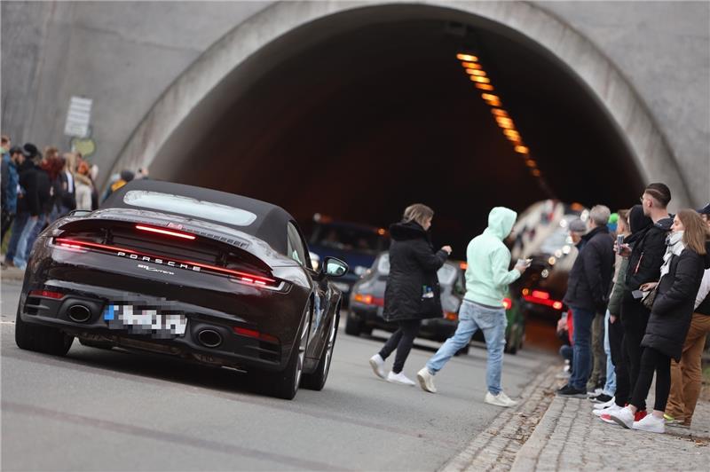 Was die „Soundröhre“ im Harz so besonders macht Besucher eines Autotunertreffens stehen am Tunnel der Rappbodetalsperre und beobachten die Fahrzeuge im Tunnel. Fans der Tunerszene haben sich zum „Car-Freitag“ den Tunnel, die sogenannte „Soundröhre“, als beliebten Treffpunkt der Szene ausgesucht. Foto: Matthias Bein/dpa