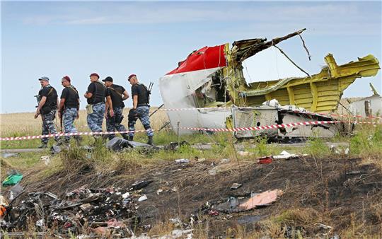 Bewaffnete Separatisten im Juli 2014 neben einem Trümmerteil der Malaysia-Airlines-Maschine im Osten der Ukraine.
