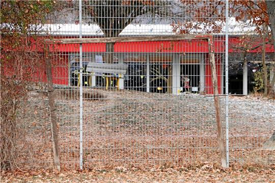Blick durch Ballfanggitter und altes Tor auf den evangelischen Regenbogenkindergarten. Der Neubau der Kindertagesstätte soll auf dem Gelände des benachbarten Bolzplatzes entstehen, informiert Bürgermeister Alf Hesse.  Foto: Gereke