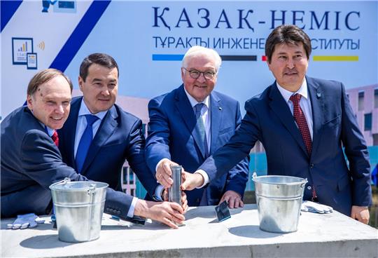 Bundespräsident Frank-Walter Steinmeier (2.v.r) legt gemeinsam mit Berik Ahmetov (r), Alichan Smajylow (2.v.l.) und Wolrad Rommel (l) den Grundsteinlegung für das Deutsche Institut für nachhaltige Ingenieurwissenschaften.