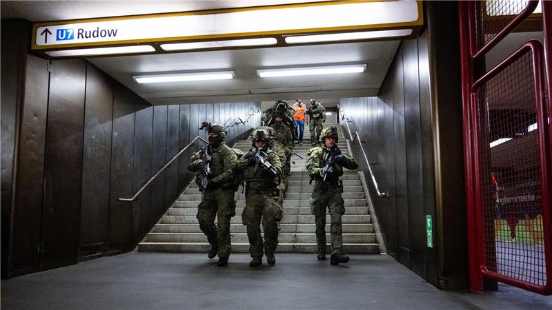 Bundeswehrsoldaten laufen bei einer Übung eine Treppe im U-Bahnhof Jungfernheide in Berlin herunter. 