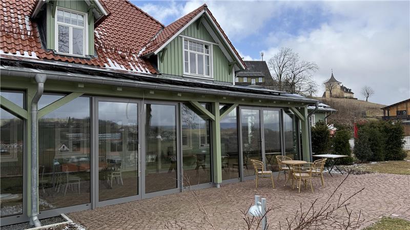 Das Foto zeigt ein Haus mit großem Wintergarten.