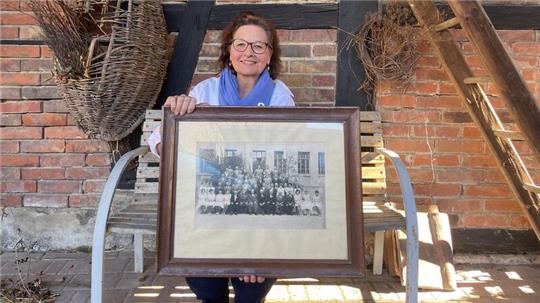 Dagmar Mönnecke-Koroma hält ein Bild des Immenröder Gesangvereins von 1961 in den Händen.
