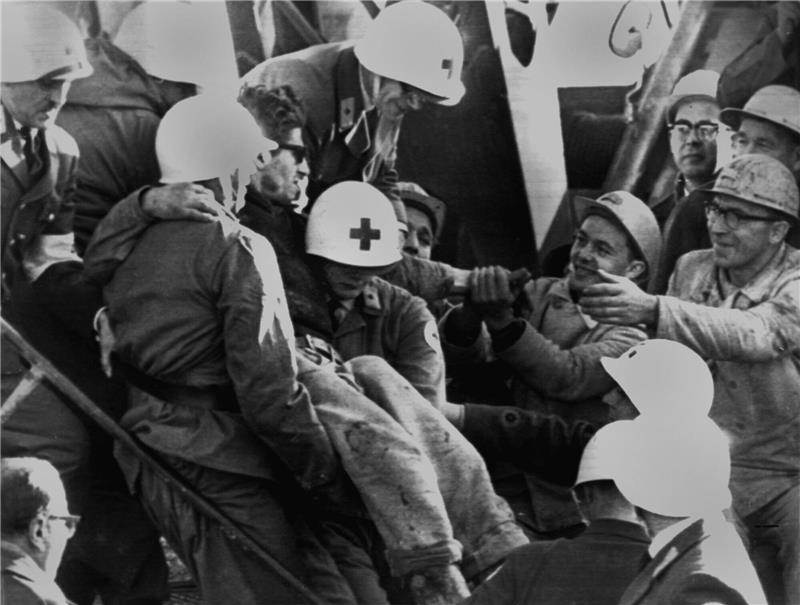 Das Archivbild vom 7. November 1963 zeigt Sanitäter im niedersächsischen Ort Lengede, die einen der elf geretteten Bergleute ins Freie tragen. Nach 14 Tagen, am 7. November 1963, wurden zehn eingeschlossene Bergleute und ein Elektriker lebend aus 60 Metern Tiefe geborgen. Sie hatten in einer Luftblase überlebt. Foto: dpa