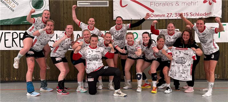 Gruppe von 14 Frauen in Sportkleidung posiert in einer Sporthalle vor einer Wand mit Bannern