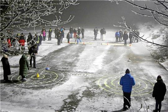 Das von der Feuerwehr aufgebrachte Wasser ist auf dem Schützenplatz bei vier Grad minus zu einer Eisdecke gefroren, die eine perfekte Unterlage für das Eisstockschießen am Samstagabend bildet. Nach zwei Jahren Corona-Pause ist die Beteiligung an der Traditionsveranstaltung besonders hoch. Fotos: Jung