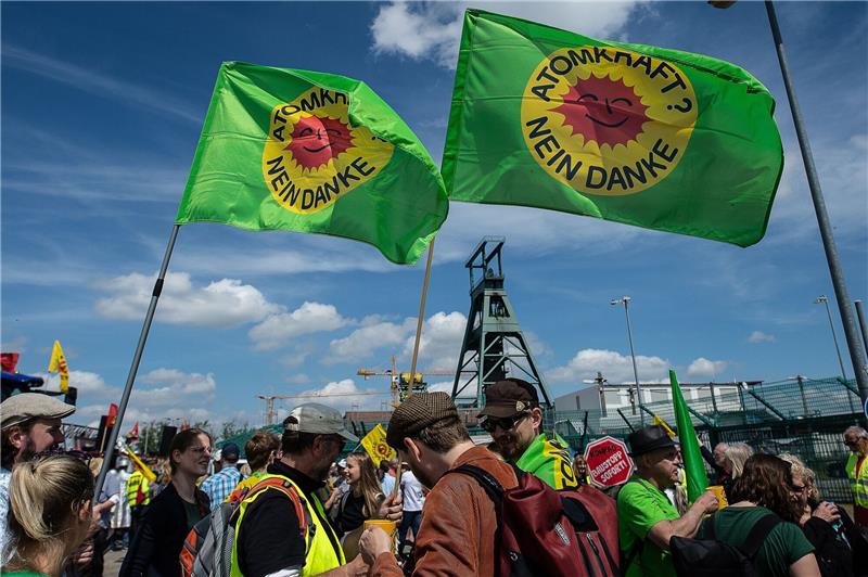 Gegner von Schacht Konrad wollen Endlager weiter verhindern Demonstranten stehen mit Flaggen vor dem ehemaligen Erzbergwerk «Schacht Konrad».