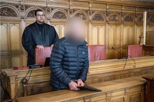 Der Angeklagte steht vor Prozessbeginn mit seinem Anwalt Temba Hoch im Gerichtssaal.