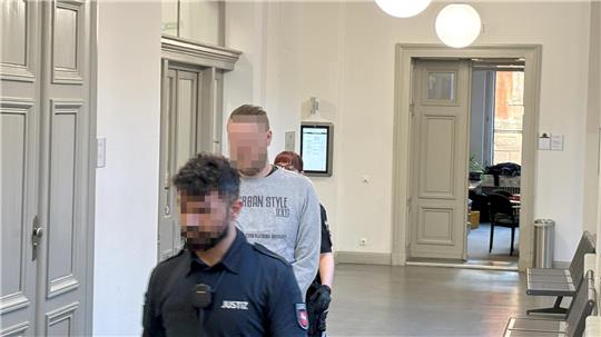 Der Angeklagte wird zum Gerichtssaal geführt.