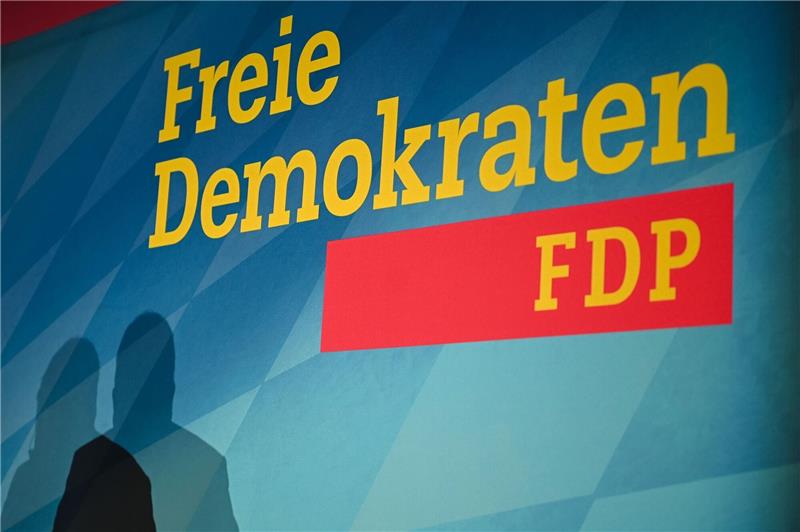 Hochrechnungen: FDP in Niedersachsen unter fünf Prozent Der Schatten eines Redners, aufgenommen vor dem Logo der FDP.
