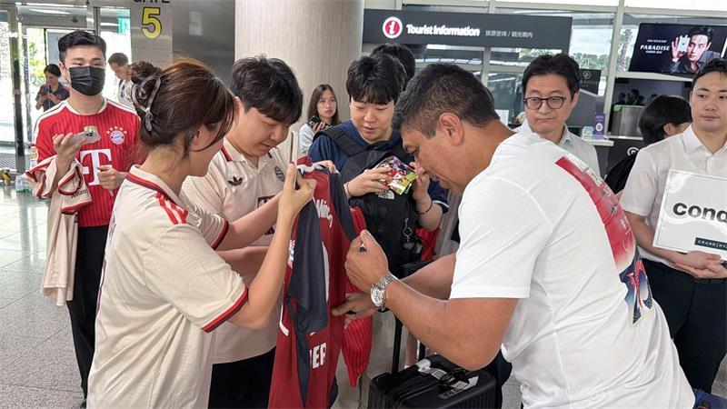 Der frühere Bayern-Profi Giovane Elber gibt Autogramme am Flughafen.