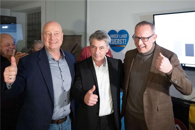 Der sächsische AfD-Generalsekretär Jan Zwerg (l-r), AfD-Kandidat Tim Lochner und der sächsische AfD-Vorsitzende Jörg Urban jubeln während der Wahlparty ihrer Partei.