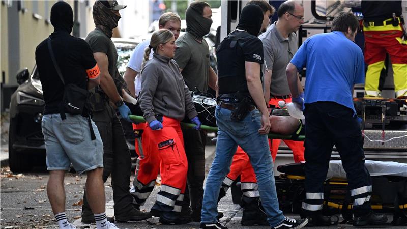 Der verletzte Tatverdächtige, der eine Lehrerin mit einem Messer angegriffen haben soll, wird zu einem Rettungswagen gebracht.