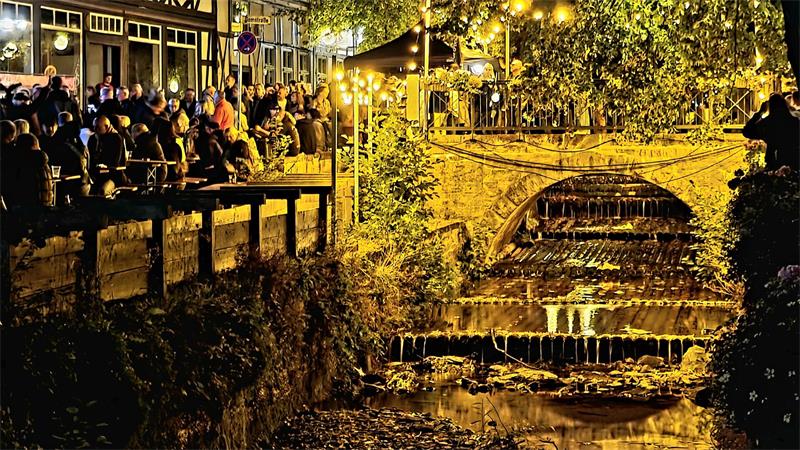 Gold beleuchteter Fluss mit vielen Menschen. 