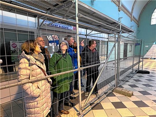 Die Bundestagsabgeordnete Karoline Otte (im grünen Mantel) und andere Politikerinnen und Politiker aus Stadt und Land lassen sich von Bürgermeister Ralf Abrahms (im blauen Anorak) den Bahnhof zeigen. Die Halle ist wegen des desolaten Dachs nur noch unter abgegitterten Schutzdächern zu betreten. Fotos: Schlegel
