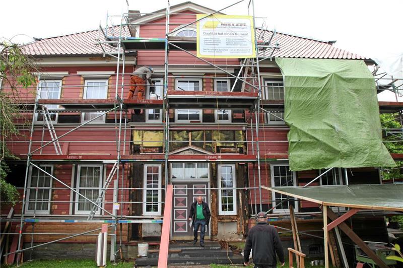 Die Fassade erhält einen neuen Anstrich in der bestehenden Originalfarbgebung. Im Eingangsbereich sind Holzarbeiten am Gebälk erforderlich.  Fotos: Bertram