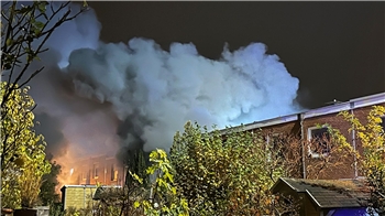 Auf dem Bild ist eine graue Rauchwolke zu sehen, die aus einem Wohnhaus aufsteigt.