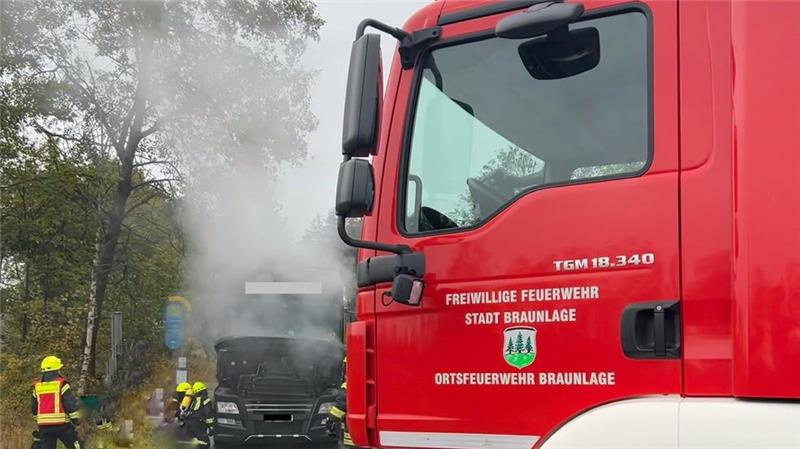 Die Feuerwehrleute kippen die Fahrgastzelle des Lastwagens, um besser löschen zu können.