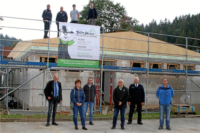 Die Firma Hesse aus Bad Grund hat das Holz für das Richtfest in Wildemann angeliefert. Architekt Andreas Bienert, Inis Müller und Fabian Gerstenberg aus dem Bauamt, Ortsbürgermeister Arno Schmidt, Stadtbrandmeister Andreas Hoppstock und Ortsbrandmeister Michael Habekost (von links) freuen sich über die schnellen Fortschritte am Neubau in der Bahnhofstraße.  Foto: Knoke
