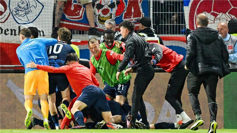 Heidenheim bleibt erstklassig - Elversberger Traum geplatzt Die Heidenheimer Spieler feiern ausgelassen.