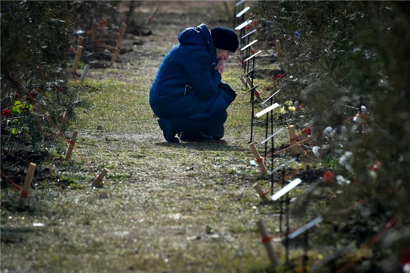 Kiew: Mehr als 200.000 russische Soldaten gefallen Die Mutter eines russischen Soldaten, der in der Ukraine getötet wurde, kniet neben einem Baum, der zum Gedenken an ihren Sohn in Sewastopol auf der Krim gepflanzt wurde.