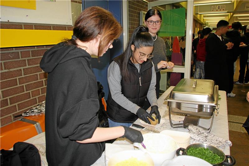 Die Ofenkartoffeln werden von den Schülerinnen je nach Wunsch mit Quark, Käse, Schnittlauch und Speck befüllt. Foto: Jenzora
