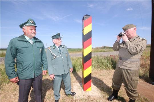 Die Originaluniformen haben die Mitglieder des Abbenröder Grenzerkreises in ihrer „Kleiderkammer“ schon herausgesucht. An der Replik einer DDR-Grenzsäule darf jetzt auch gelacht werden – geblieben ist aber das Fotografieren der jeweils anderen Seite. Fotos: Gereke