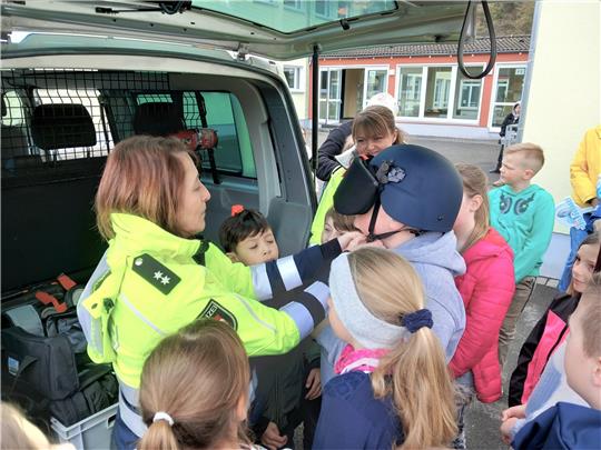 Die Polizei-Oberkommissarinnen Melanie Rost (li.) und Melanie Liebezeit (halb verdeckt) zeigen den Schülern aus Wolfshagen und Lautenthal, wie ein Polizeifahrzeug ausgestattet ist. Foto: Neddermeier