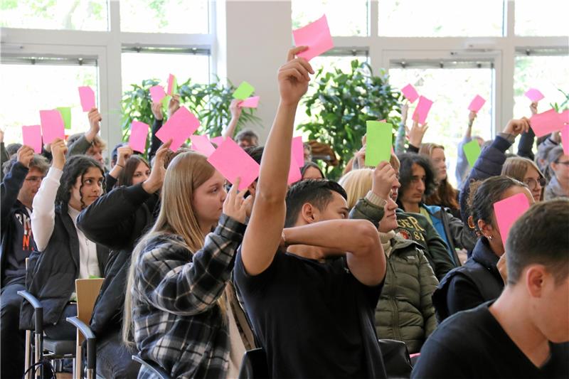 BBS1-Schüler diskutieren Zukunfts-Chancen und Zukunfts-Ängste Die Schülerinnen und Schüler können mit der pinken oder grünen Karte auf Fragen reagieren. Foto: Otte