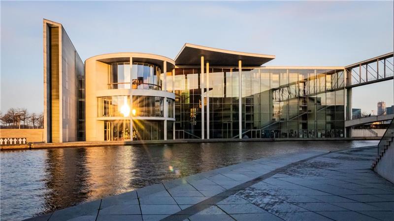 Die aufgehende Sonne spiegelt sich im Paul-Löbe-Haus des Deutschen Bundestag.