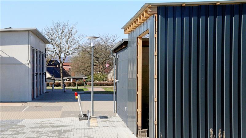 Bevölkerungsschutz: Wofür Liebenburg jetzt mehr Geld ausgibt Eine kleine Lagerhalle im Vordergrund, im Hintergrund der Tore einer Feuerwehr-Fahrzeughalle.