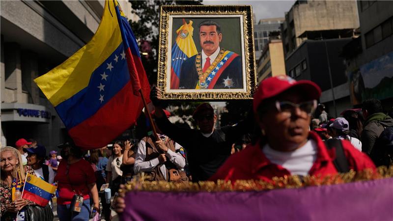 Ein Anhänger der Regierung hält ein Bild von Präsident Nicolas Maduro.