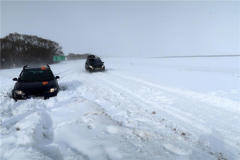 Chaos durch Schneestürme in Osteuropa Ein Auto ist auf der Straße zum Flughafen in Pograd in der Slowakei im Schnee stecken geblieben.