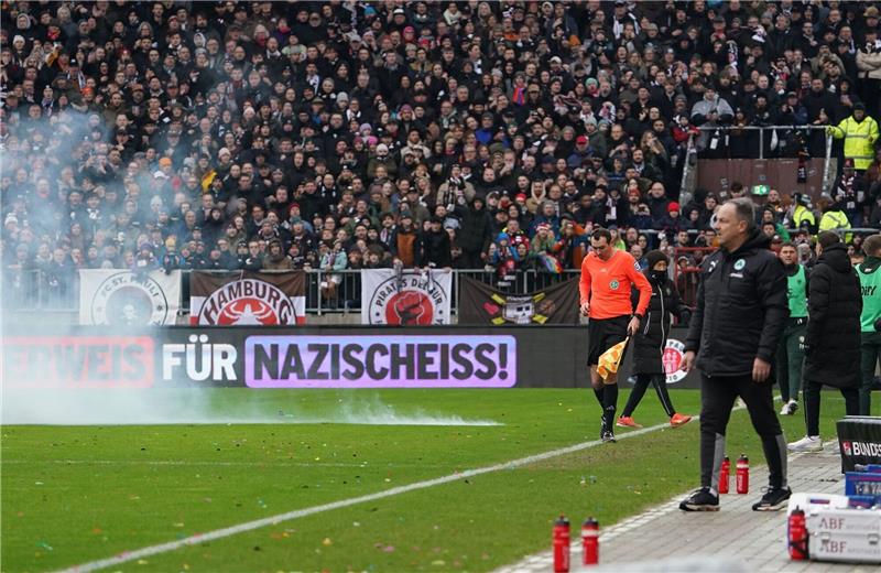 Pauli-Trainer Hürzeler über Böllerwurf: „Riesenglück gehabt” Ein Böller explodiert am Millerntor in der Nähe der Trainerbänke.