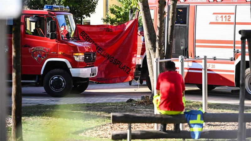 Ein Feuerwehrmann sitzt in der Nähe des Tatorts. 