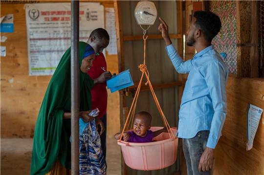 Ein Kind wird in einem Flüchtlingslager in Somalia gewogen.