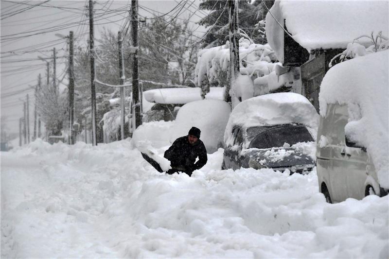 1000 Orte nach Wintereinbruch in Bulgarien ohne Strom Ein Mann in Isperich schaufelt Schnee, um sein Auto zu befreien.