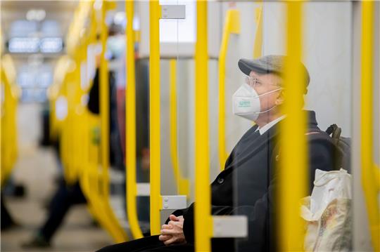 Ein Mann sitzt mit FFP2-Maske in der U-Bahn in Berlin.