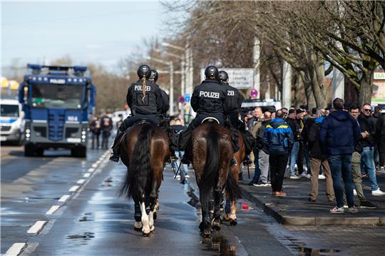 Ein Wasserwerfer der Polizei steht vor dem Spiel nahe dem Eintracht-Stadion hinter der Reiterstaffel. Foto: Swen Pförtner/DPA