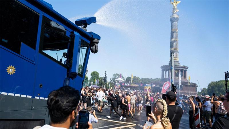 Hitzeschlacht im Techno-Takt: Parade gegen Terrorangst Ein Wasserwerfer der Polizei verschafft den Ravern etwas Abkühlung.