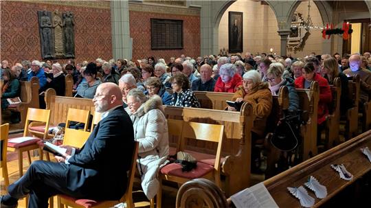 Ein eher untypischer Anblick: Während des Adventsliedersingens schauen viele Gemeindemitglieder lieber auf ihr Smartphone statt ins gedruckte Gesangbuch.