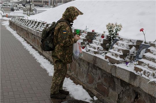 Ein ukrainischer Soldat gedenkt in Kiew den Menschen, die bei Zusammenstößen mit Sicherheitskräften auf dem Maidan-Platz im Jahr 2014 ums Leben kamen.