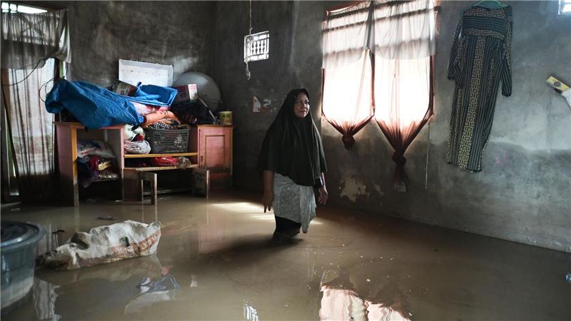 Eine Frau steht nach heftigen Monsun-Regenfällen in Indonesien in ihrem überfluteten Haus